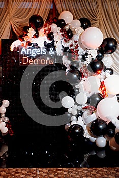 A photo zone themed angels and demons in black with white and black balls