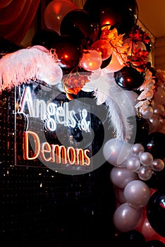 A photo zone themed angels and demons in black with white and black balls