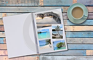 Photobook Album with Travel Photo on Wooden Floor Table with Coffee or Tea in Cup