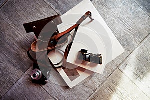 Photobook in bright leather, retro binoculars and old camera. Creative