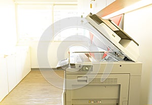 A photocopier machine and full access control of key card scanning panel in office.