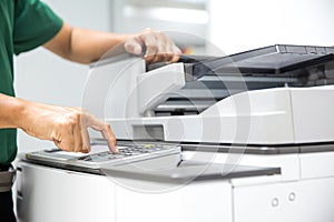 Photocopier printer, Close up hand office man press copy button on panel to using the copier or photocopy machine for scanning