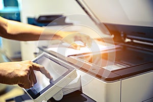 Photocopier printer, Close up hand office man press copy button on panel to using the copier or photocopy machine for scanning