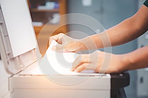 Photocopier printer, close up hand office man using the copier or photocopy machine for scanning document or printing paper or