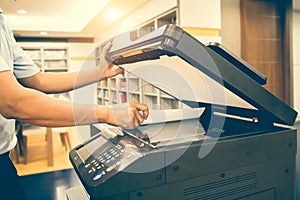 Photocopier printer, Close up hand scanning paper on the copier or photocopy machine concept of office workplace equipment for