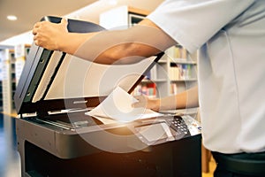 Photocopier printer, Close up hand scanning paper on the copier or photocopy machine concept of office workplace scan document or