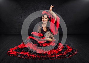 Photogenic Spanish dancer sits on stage