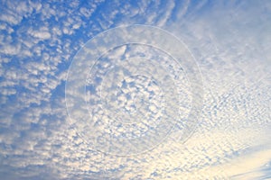 Abstract Pattern of White Cirrocumulus Clouds in Infinite Blue Sky - Natural Background photo