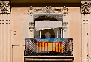 A balcony with a flag of the Valencian community photo