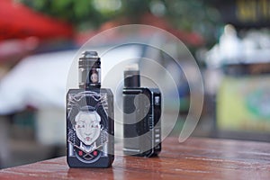 Photograph of black colored vape on the table