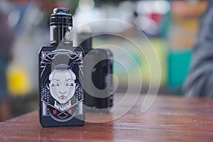 Photograph of black colored vape on the table