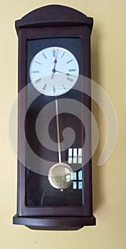 This is a photograph of a brown wood clock