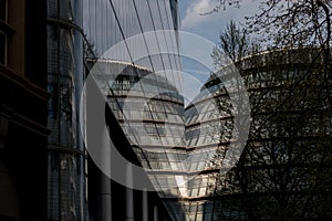 Photograph of City Hall, London taken from the rear at dusk. Building is reflected in the glass facade of the adjacent building.