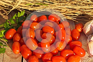 Photograph of Comer tomatoes on rustic background. photo