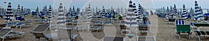 Photograph that depicts detail of Jesolo beach, lifeguards at the evening closing of umbrellas and beach cleaning to be ready for