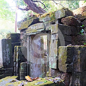 Photograph featuring the remnants of an ancient edifice in Cambodia, dominated by medieval stone ruins