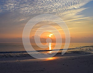 Golden Yellow Sun Rising at Horizon with Colorful Sky with Reflection in Sea Water - Kalapathar Beach, Havelock Island, Andaman