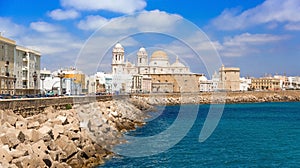 Groyne in CÃ¡diz with the Cathedral of Saint Cross in the background photo