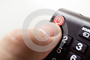 Photograph of a hand holding a television remote control