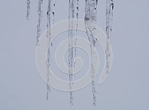 Ice sickles hanging from a roof edge. photo