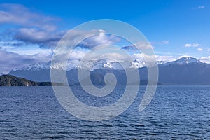 Photograph of a large lake and mountain range while driving from Te Anau to Manapouri in New Zealand