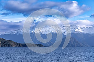 Photograph of a large lake and mountain range while driving from Te Anau to Manapouri in New Zealand