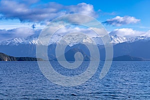 Photograph of a large lake and mountain range while driving from Te Anau to Manapouri in New Zealand