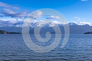 Photograph of a large lake and mountain range while driving from Te Anau to Manapouri in New Zealand