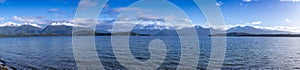 Photograph of a large lake and mountain range while driving from Te Anau to Manapouri in New Zealand