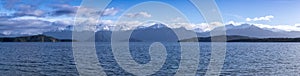 Photograph of a large lake and mountain range while driving from Te Anau to Manapouri in New Zealand