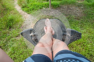 Photograph of the legs of an elephant driver. Indian elephant, top view
