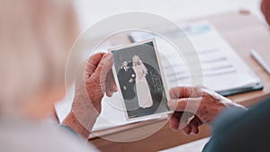 Photograph, memory and hands of old woman in home with husband and remember wedding and nostalgia for event. Elderly