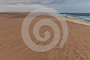 Photograph of the Namibe Desert. Coast line with desert dunes. Africa. Angola. Namibe