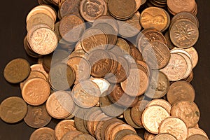 A pile of Canadian one cent coins and United States pennies