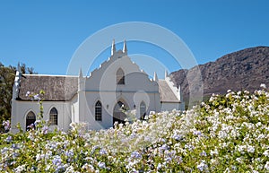 Photograph of the restored whitewashed, gabled Dutch Reformed Church in the main street in Franschhoek, South Africa