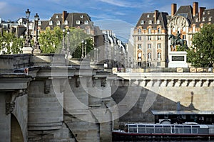 Photograph of the Royal bridge of Paris over the beautiful Seine river under a beautiful blue sky