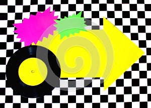 Photograph of 45rpm record with colorful shapes on Checkered floor photo