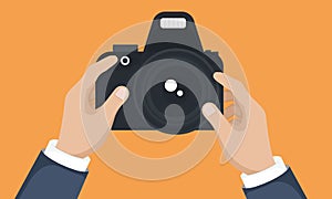 Photograph\'s hands holding dslr photo camera