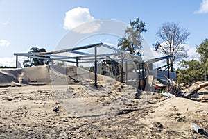 Photograph of a severely flood damaged building on the banks of the Hawkesbury river