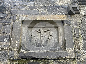 plaque with a crucifixion dated to 1625 Turlough Round Tower photo