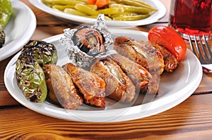 Photograph of some tasty barbecue chicken wings with salad