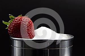Photograph of a strawberry drowned in sugar