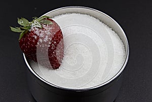 Photograph of strawberry and sugar