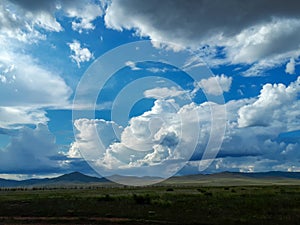 Photograph summer bright blue sky white clouds rain mountains hills green