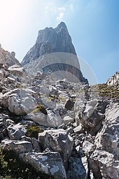 Photograph taken from the base of Picu Urriellu or Naranjo de Bulnes, with the huge stones in the foreground as you arrive photo