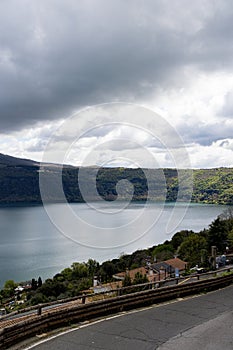 Photograph taken in Castel Gandolfo, Italy, from an elevated perspective, capturing a view of the lake and mountains