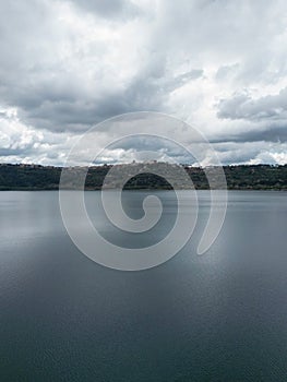Photograph taken in Castel Gandolfo, Italy, from an elevated perspective, capturing a view of the lake and mountains