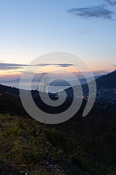 Photograph taken in Sorrento, Italy, showcasing a nighttime view of the entire city with the sunset