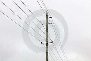 Photograph of a wooden powerline pole and wires