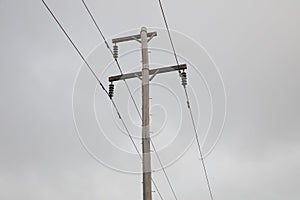 Photograph of a wooden powerline pole and wires